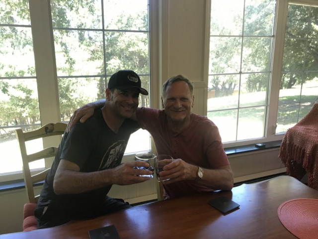 Having a drink with his son Pete. Son Pete posing for a photo with his Dad.