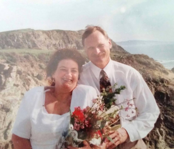 Wedding photo at the coast with wife Beverley. Sunny day at the coast, wind blowing, bride and groom pose for a pic.
