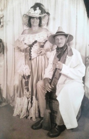 An old time style photo with his wife Beverley. Sepia toned photo with wife Beverley dressed with 1800 attire.