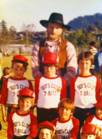 Coach Laren in T-Ball team photo with son Pete. An old photo of Laren, wearing a cowboy hat, as coach for a T-Ball team.